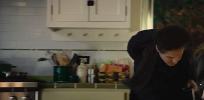 a man standing in a kitchen preparing food