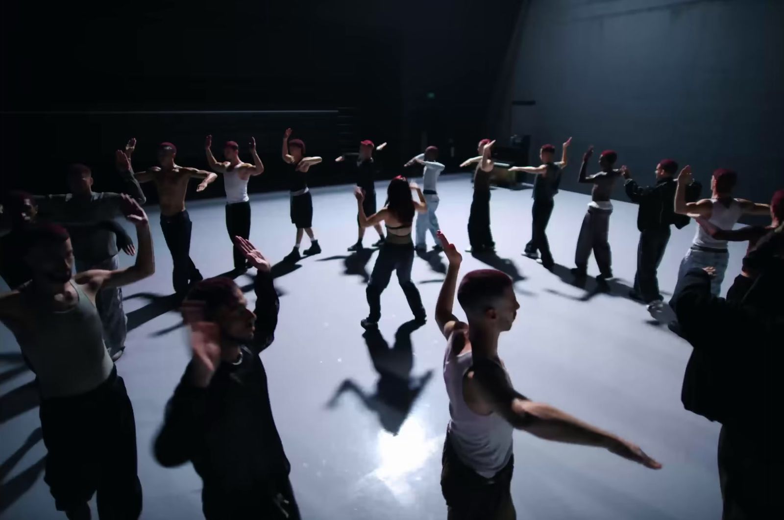 a group of people standing on top of a dance floor