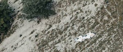 an aerial view of a plane in the snow