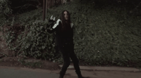 a man with long hair holding a skateboard