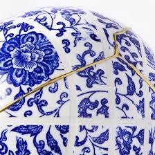 a close up of a blue and white vase