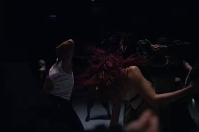 a group of people dancing in a dark room