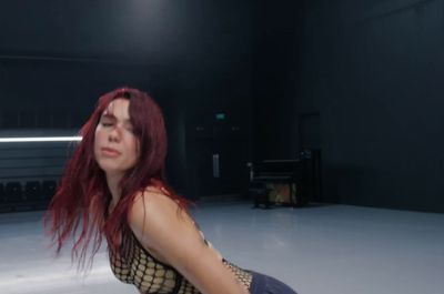 a woman with red hair sitting on the floor