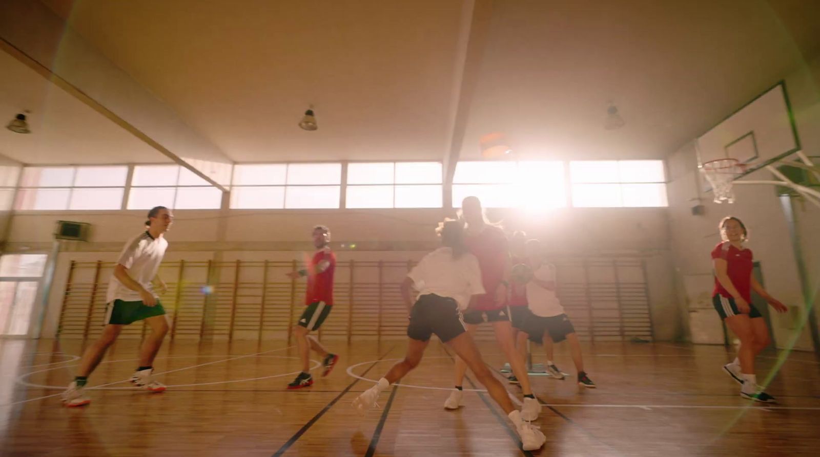 a group of young people playing a game of basketball