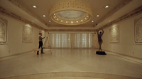 a man is standing in a room with statues