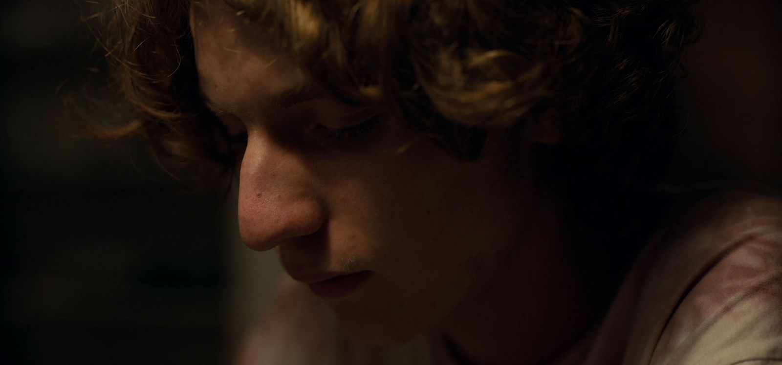 a close up of a person with curly hair