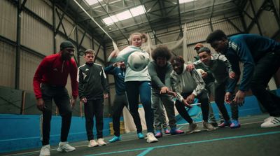 a group of people standing around a soccer ball