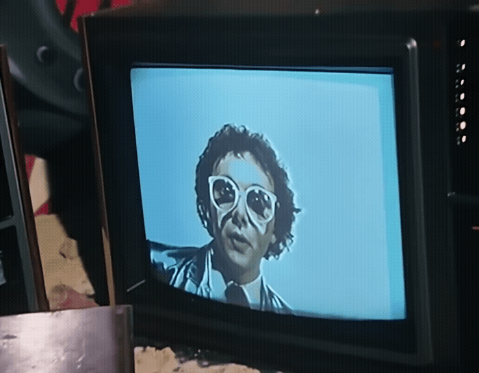 a television with a picture of a man wearing sunglasses