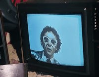 a television with a picture of a man wearing sunglasses