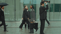 a group of business people walking down a street