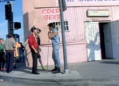 a group of people standing on the side of a road