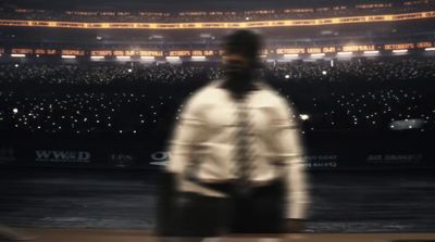 a blurry photo of a man standing in front of a stadium