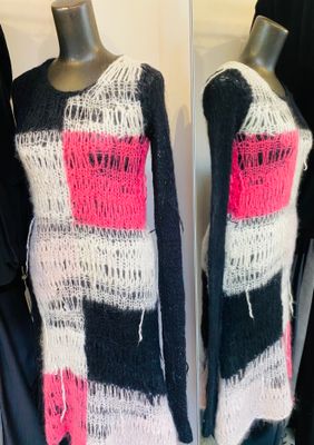 a black and white sweater with pink and black squares