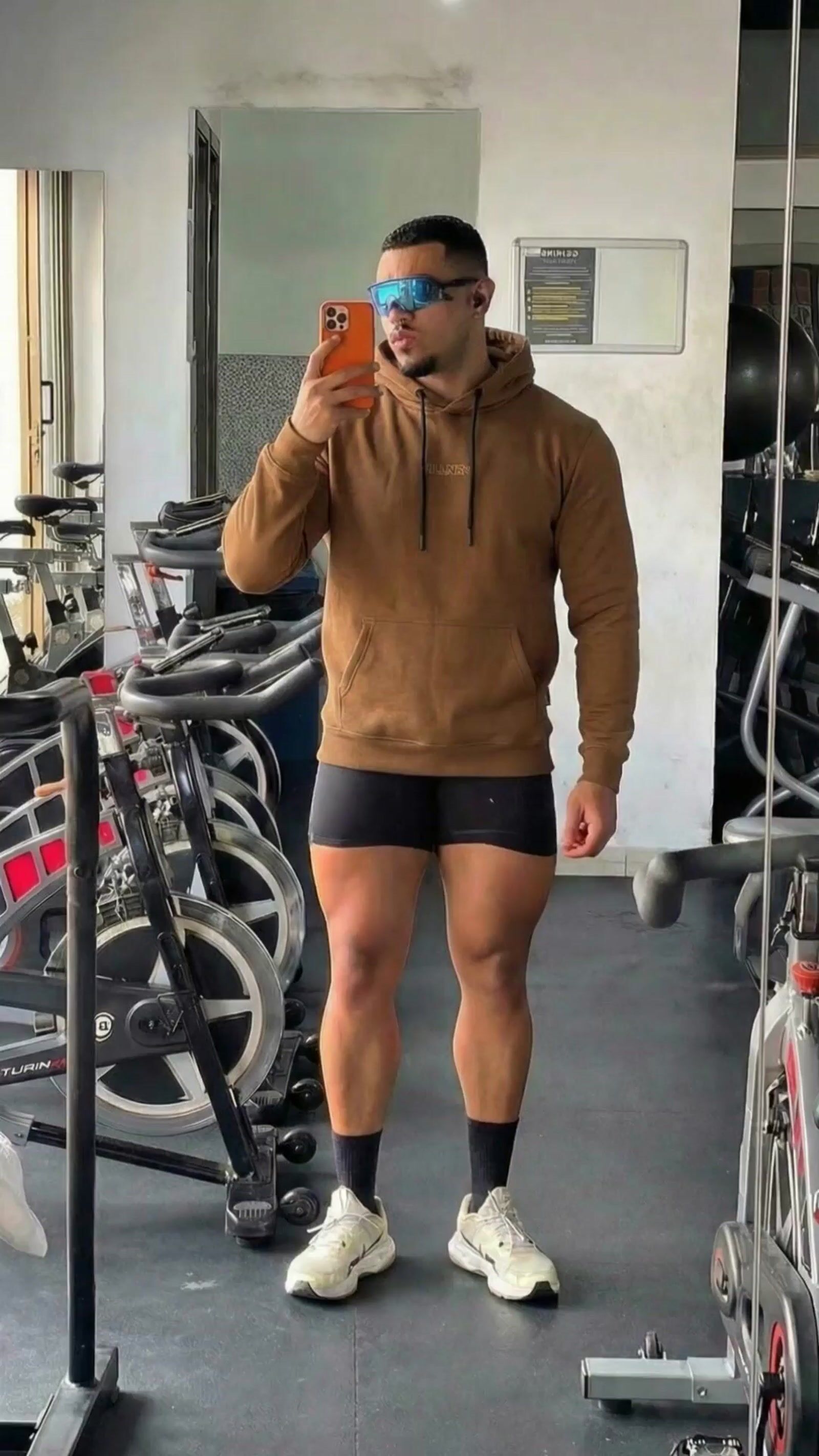 a man taking a selfie in a gym