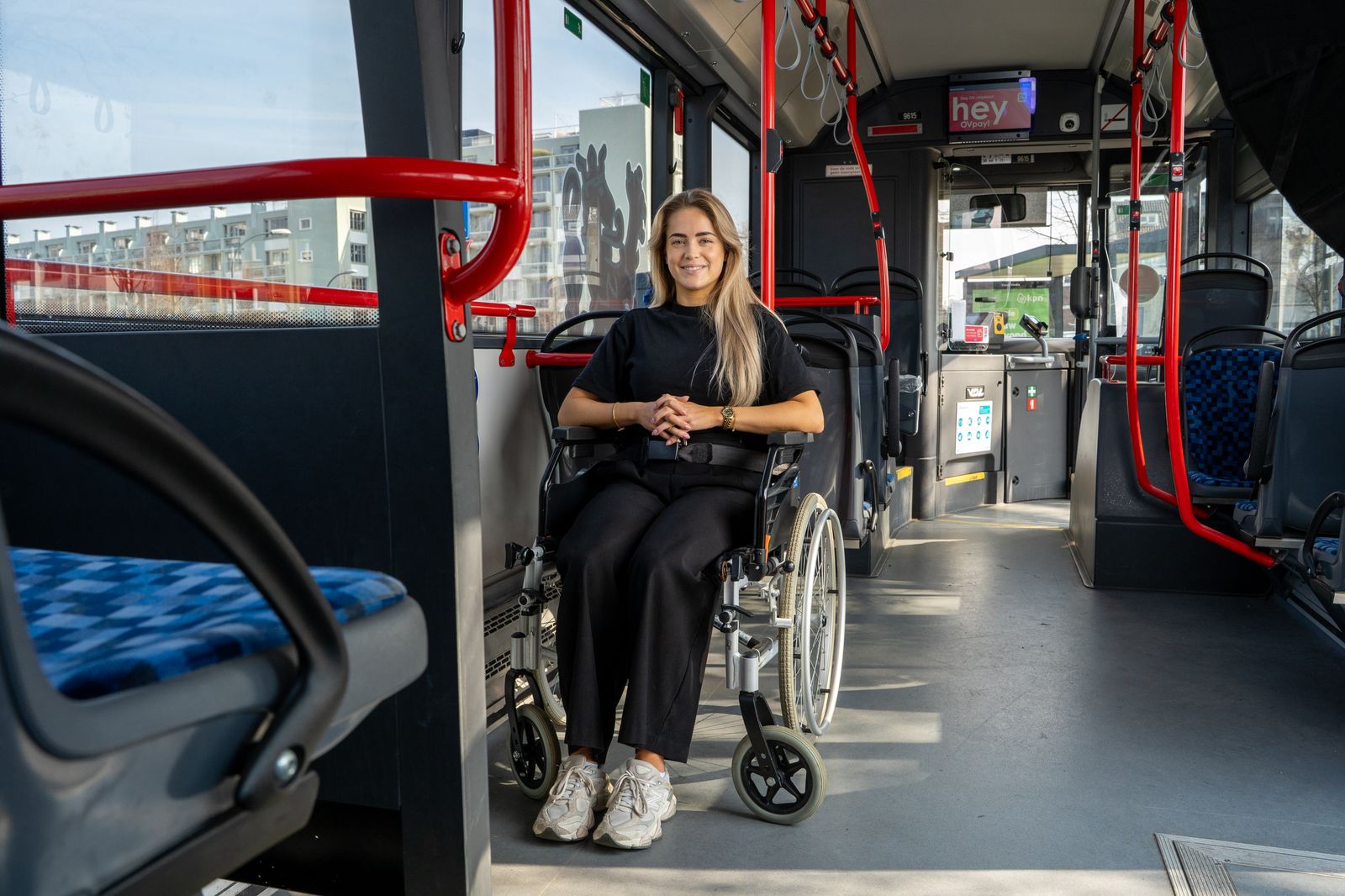 a woman sitting in a wheelchair on a bus