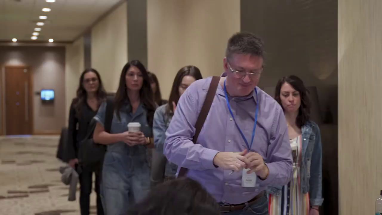 a group of people walking down a hallway