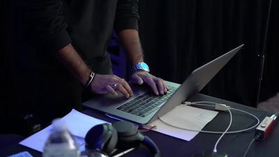 a person typing on a laptop on a table