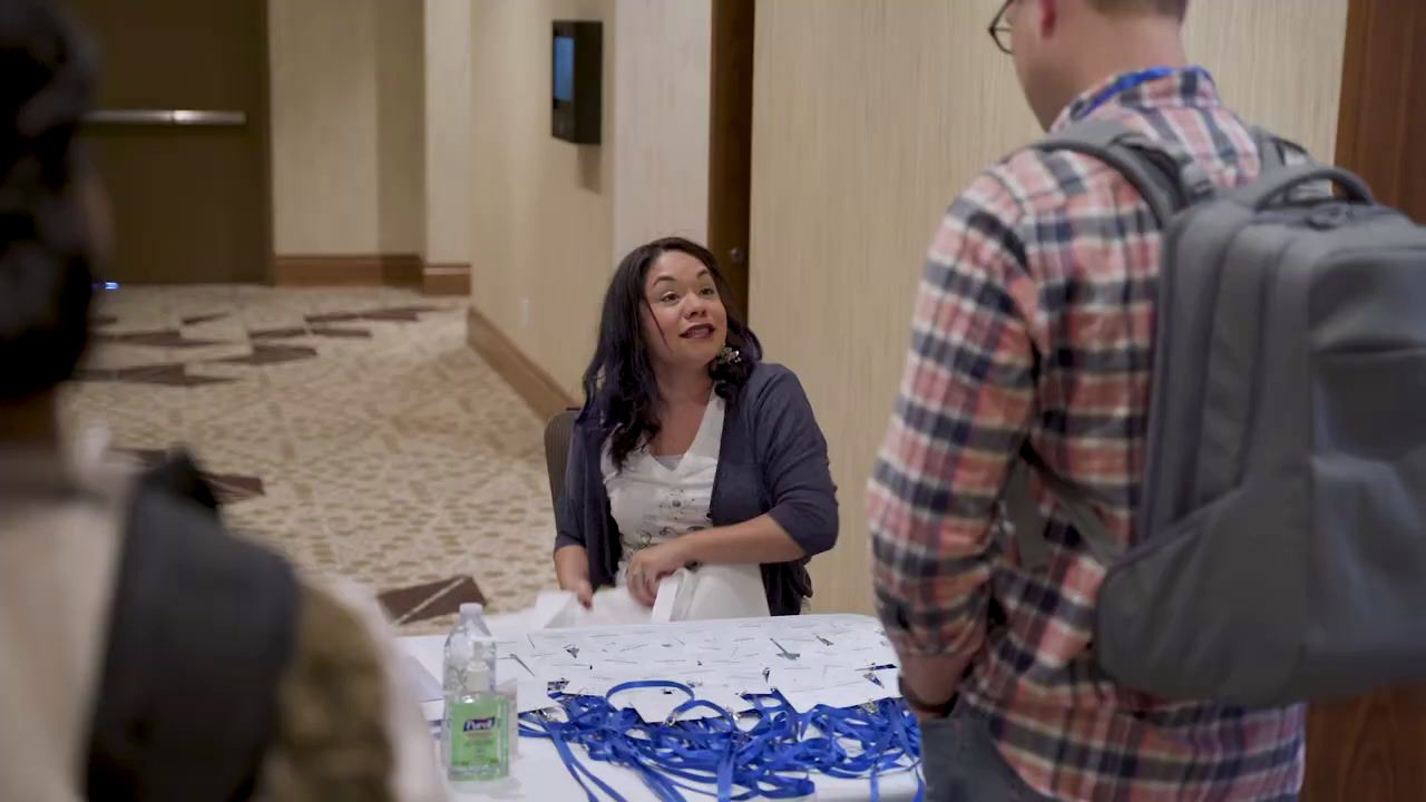 a man and a woman standing in front of a table