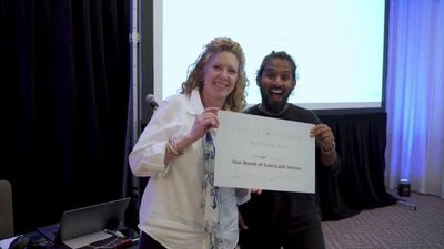 a man and a woman holding a large cheque