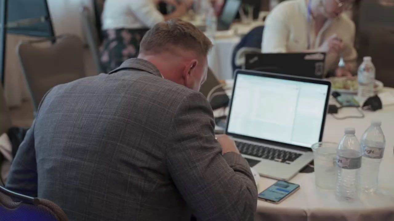 a man sitting in front of a laptop computer