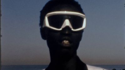 a person wearing a pair of goggles near the ocean