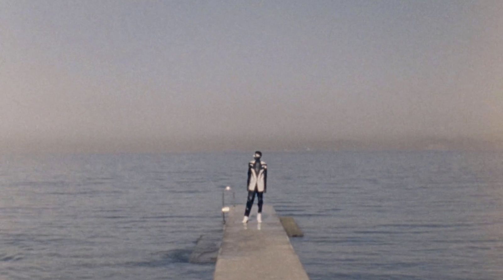 a person standing on a dock in the water