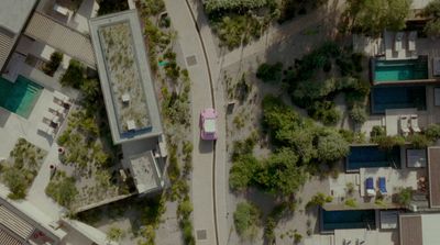 an aerial view of a parking lot and surrounding buildings