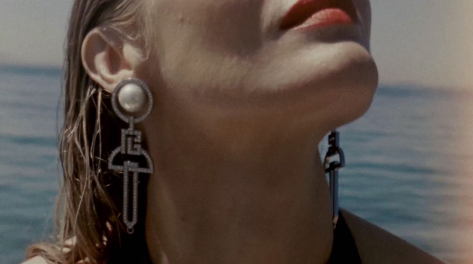 a close up of a person wearing a pair of earrings