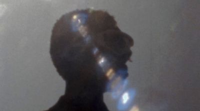 a blurry image of a person with a cell phone