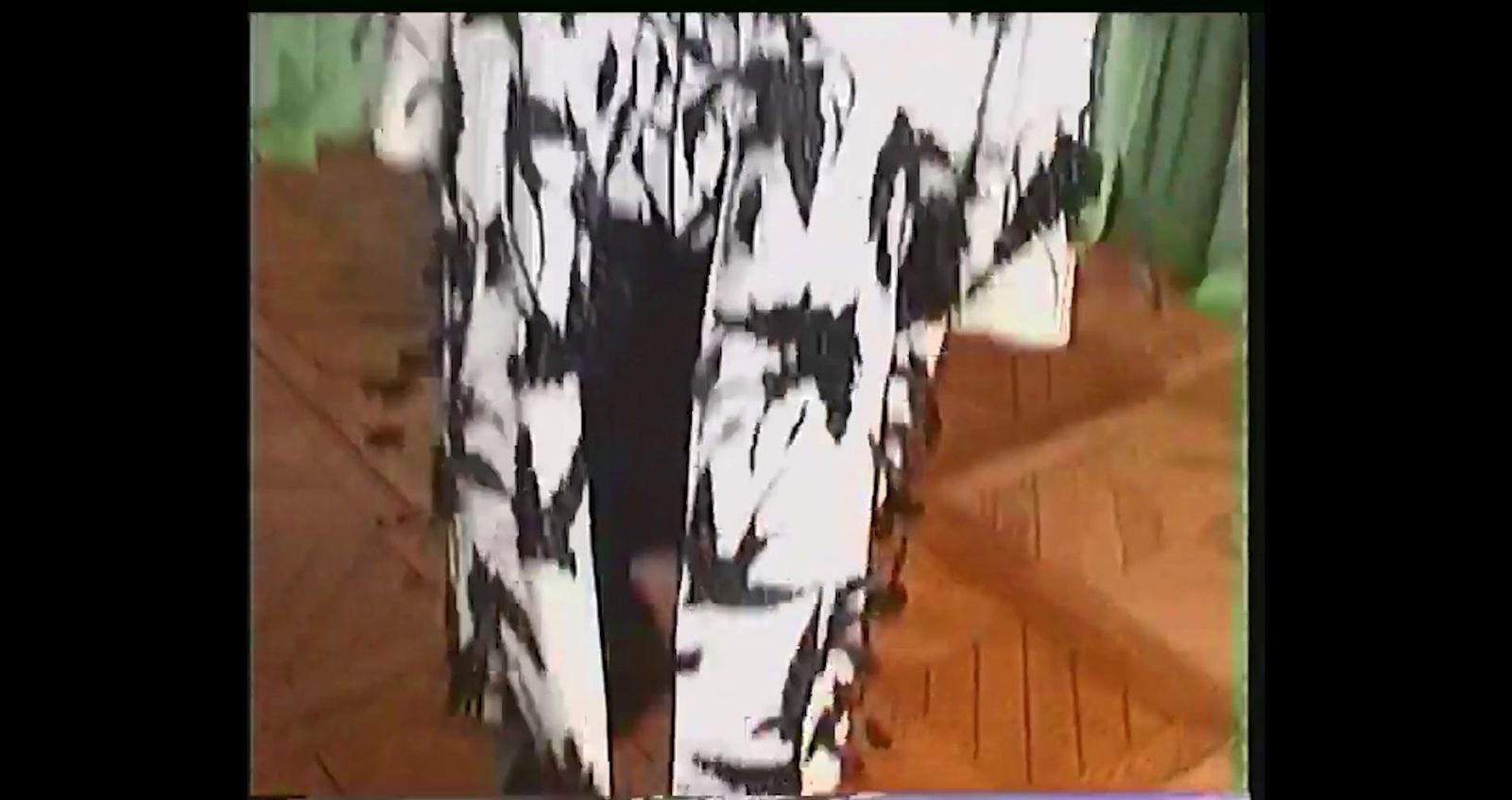 a close up of a white and black animal print pants