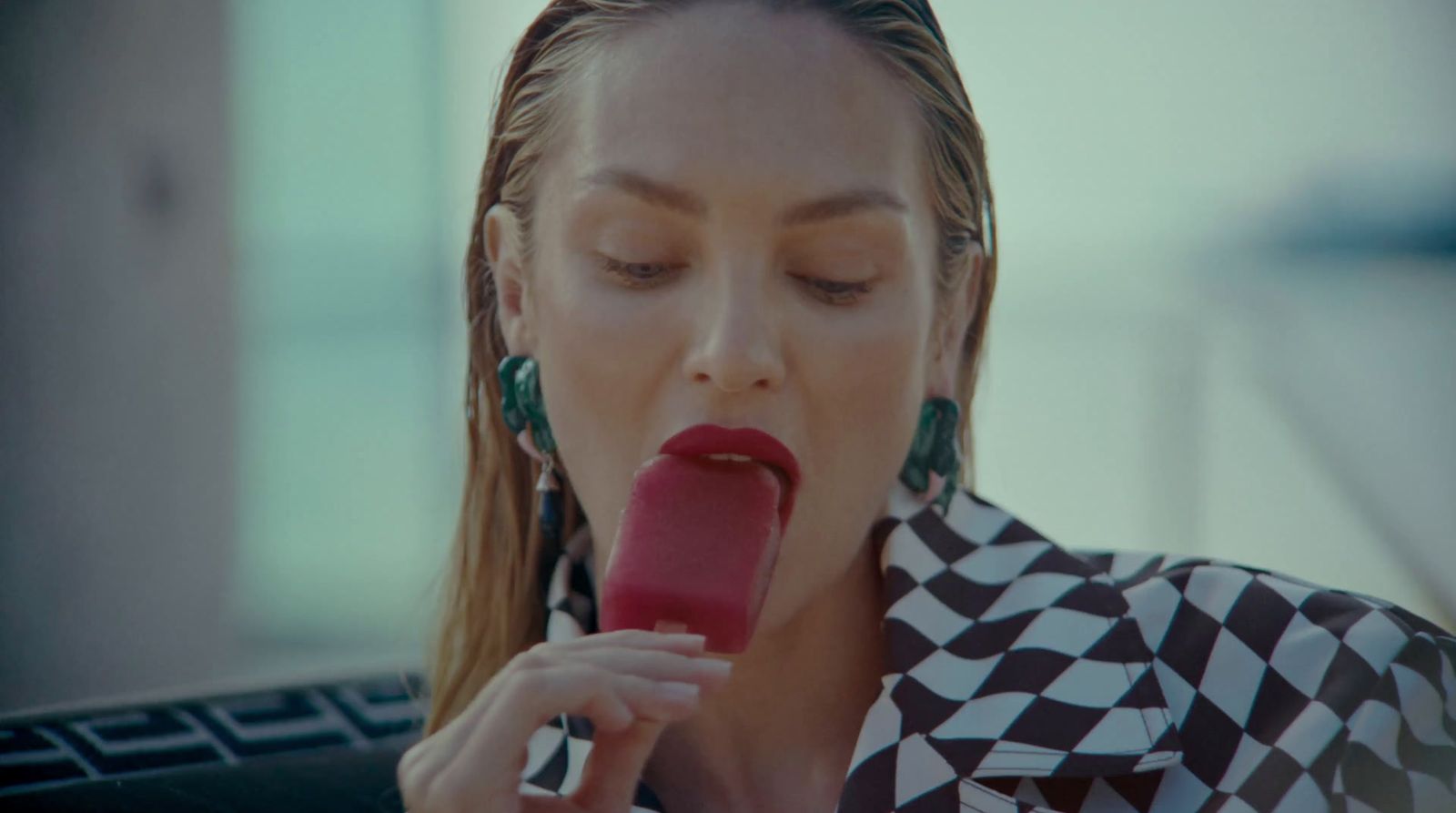 a woman with long hair eating a piece of food