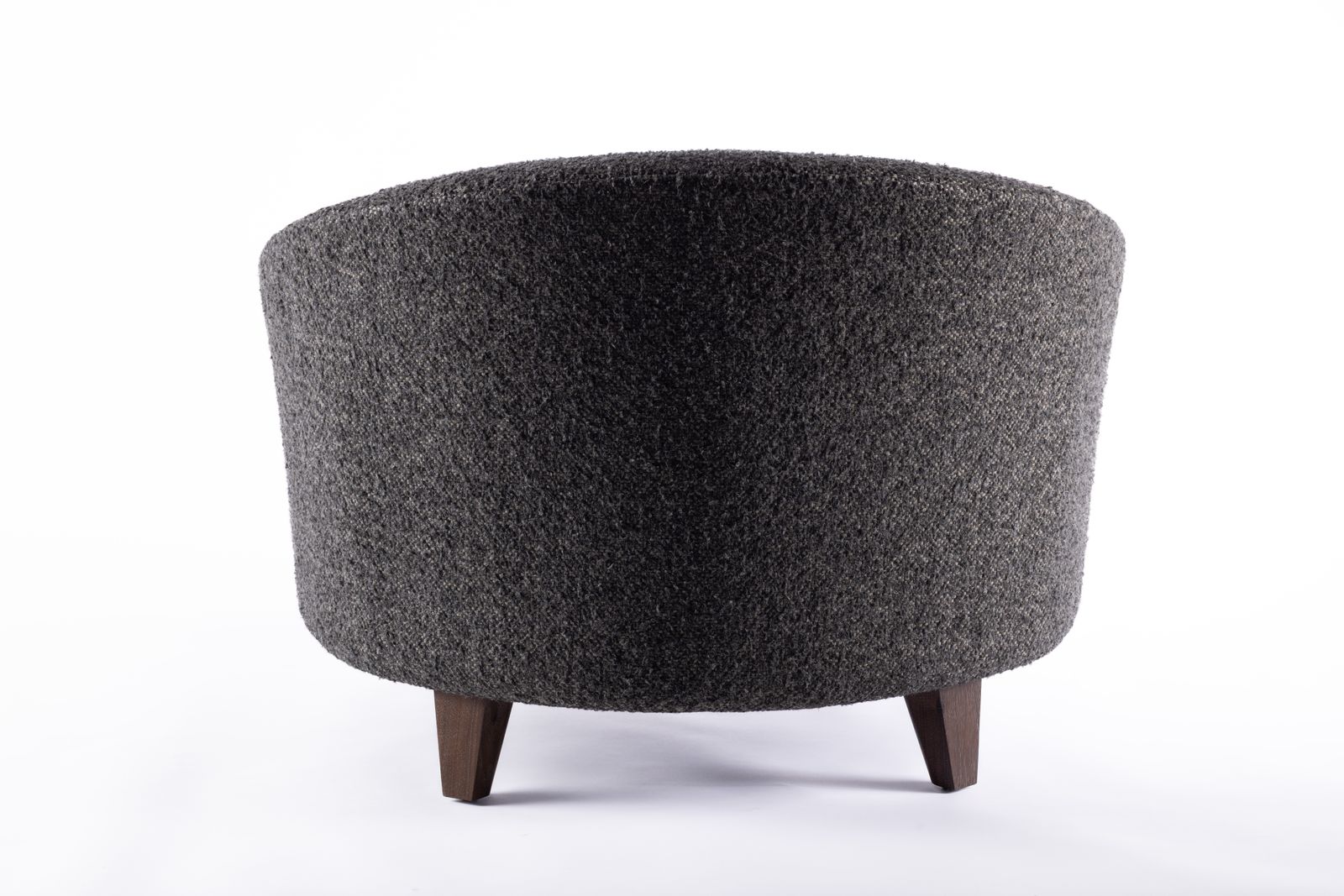 a black and gray ottoman sitting on top of a white floor