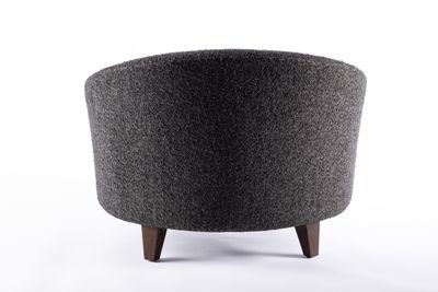 a black and gray ottoman sitting on top of a white floor