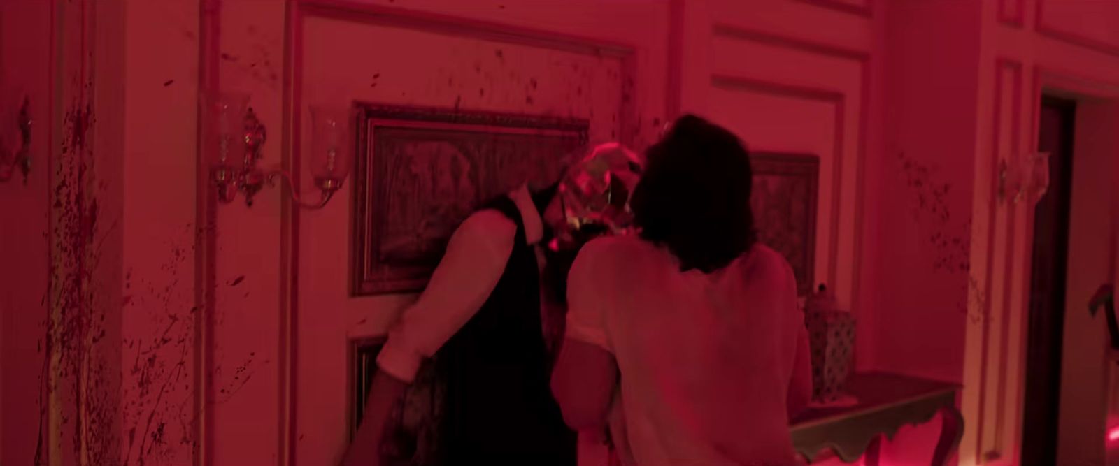 a woman standing in front of a mirror in a room