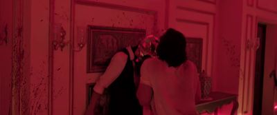 a woman standing in front of a mirror in a room