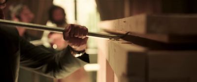 a man holding onto a bar in a room