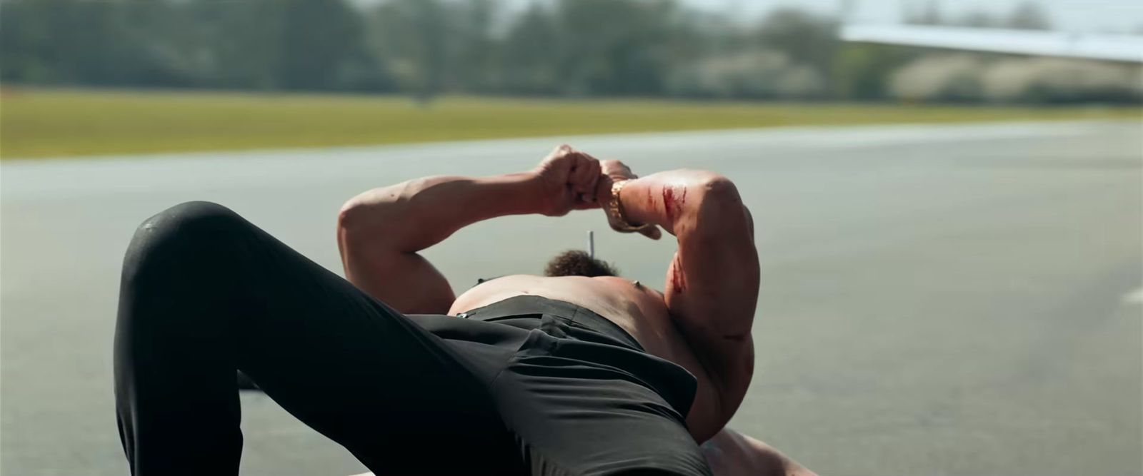 a man laying on the ground with his head in his hands