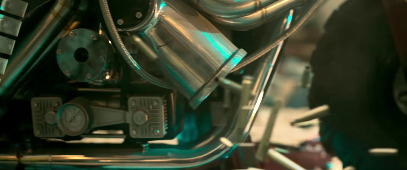 a close up of a motorcycle engine with a clock