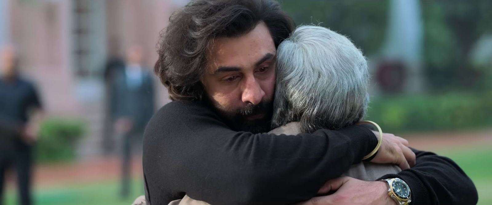 a man hugging a woman in a park