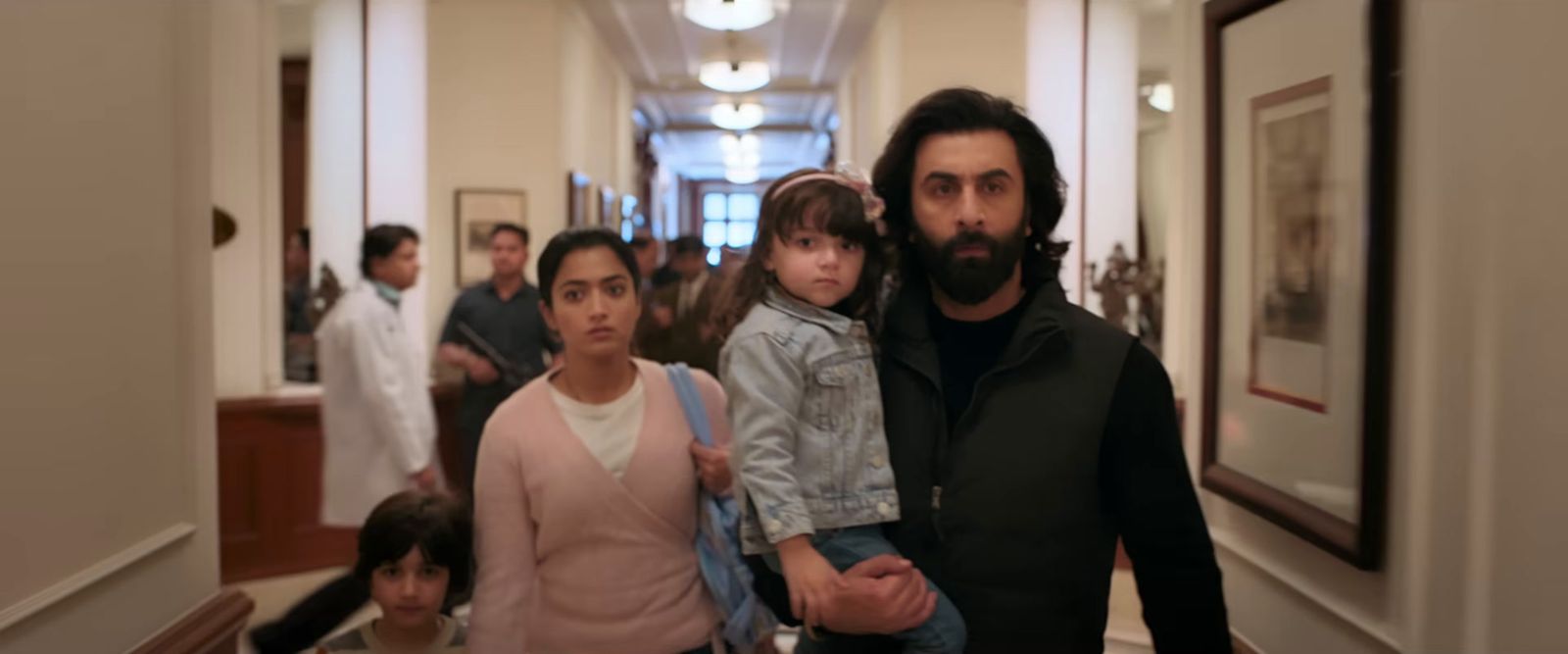 a group of people walking down a hallway