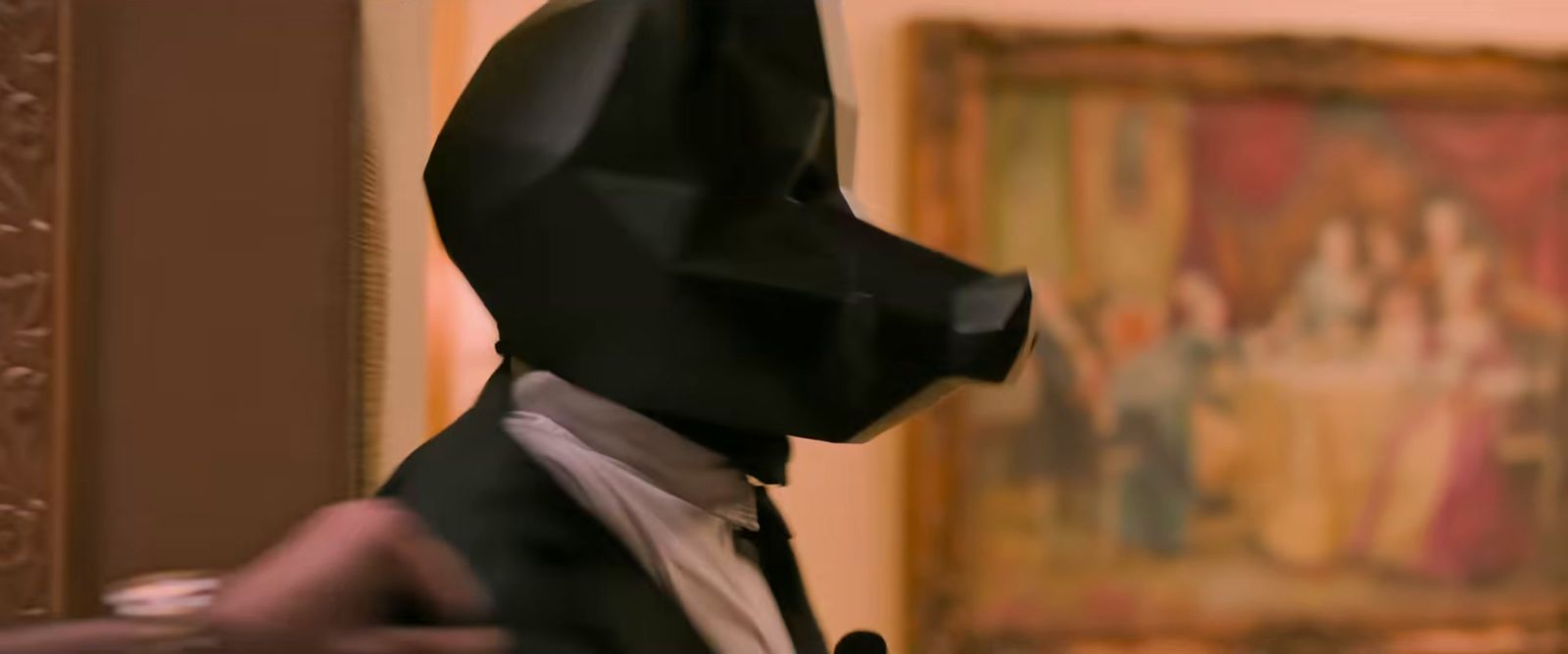 a man in a suit and tie wearing a batman mask