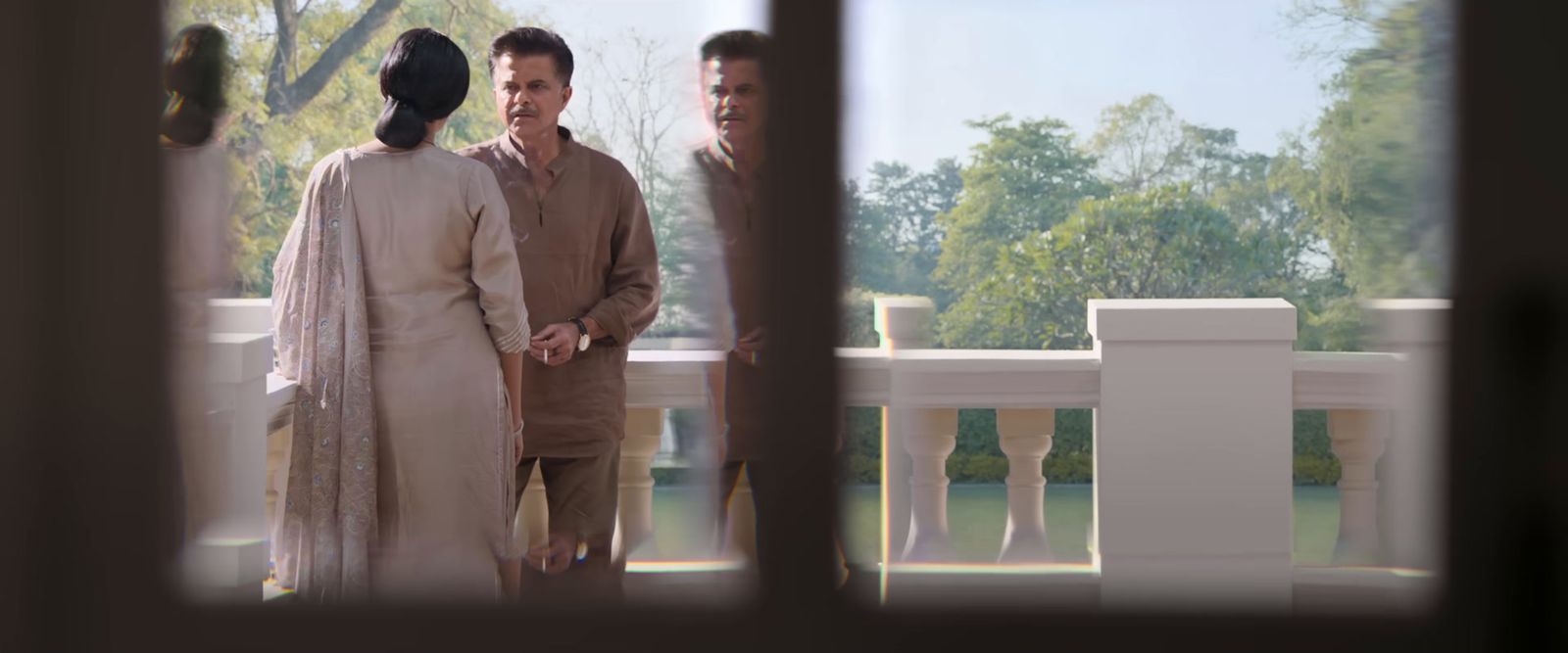 a man and a woman standing on a balcony