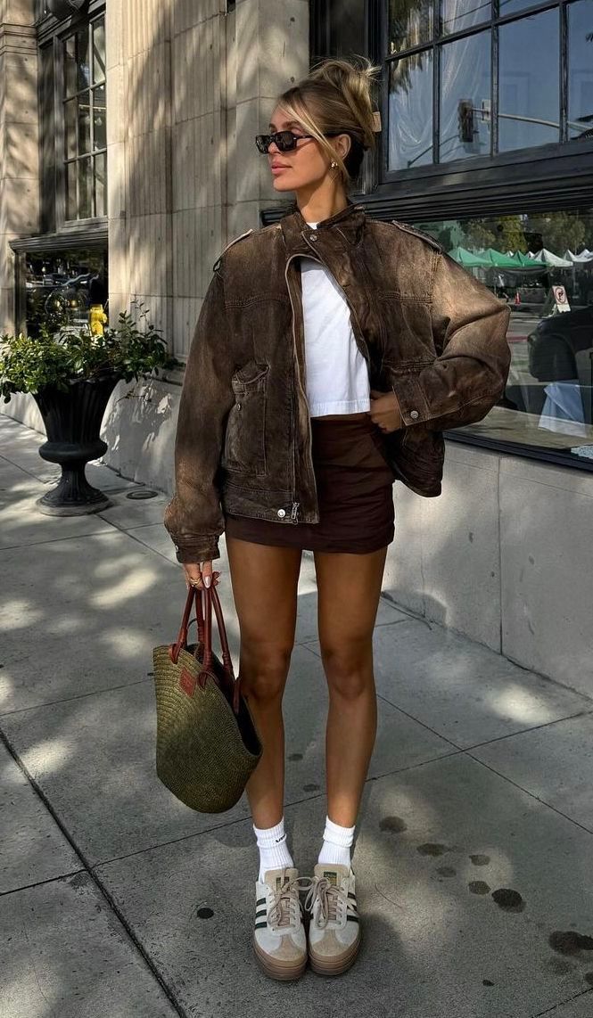 a woman is walking down the street with a handbag