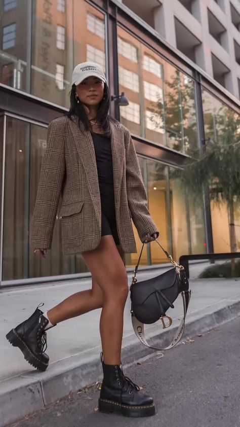 a woman is walking down the street with a handbag