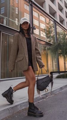 a woman is walking down the street with a handbag