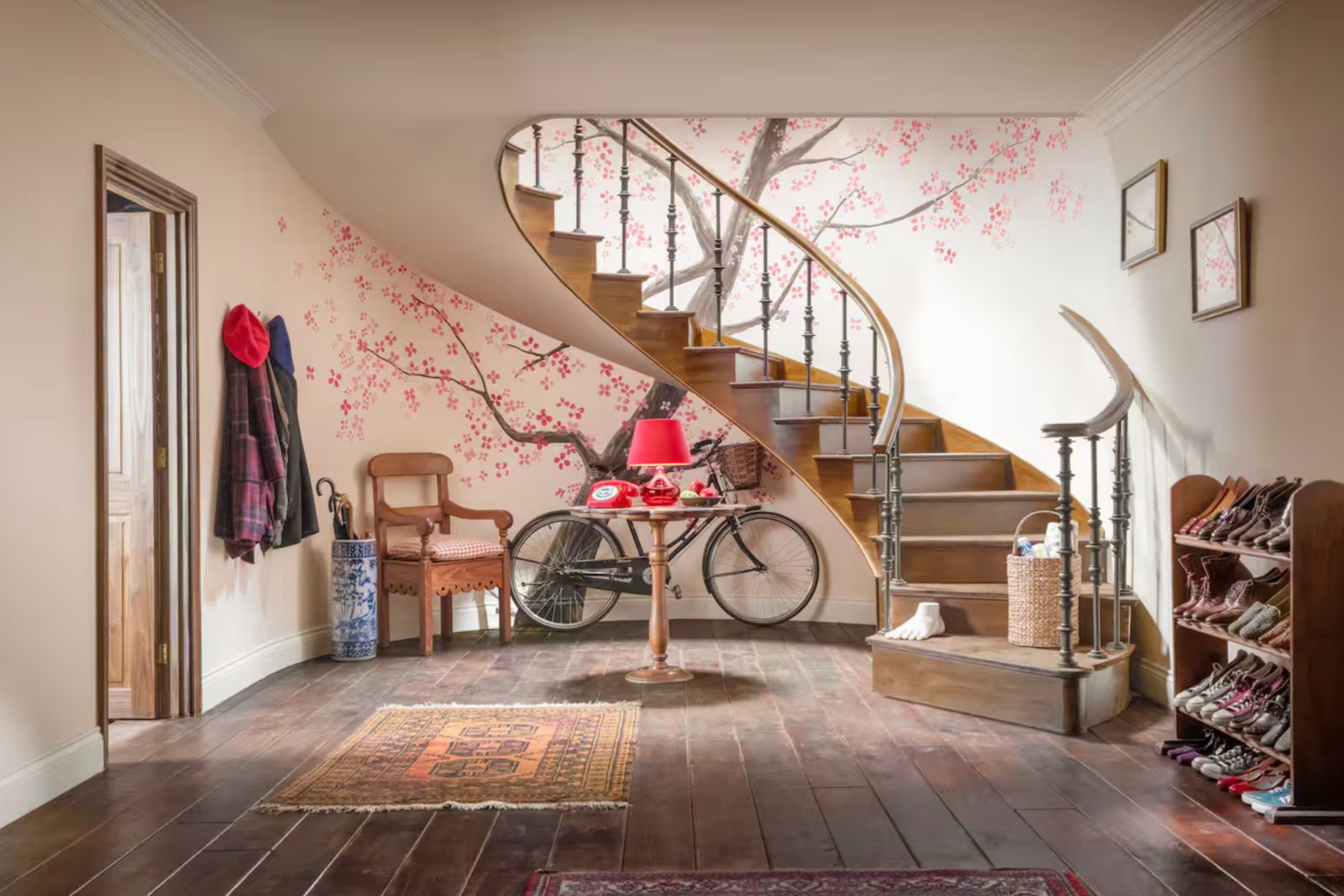 a room with a spiral staircase and a bicycle
