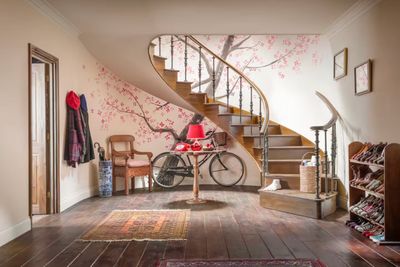 a room with a spiral staircase and a bicycle