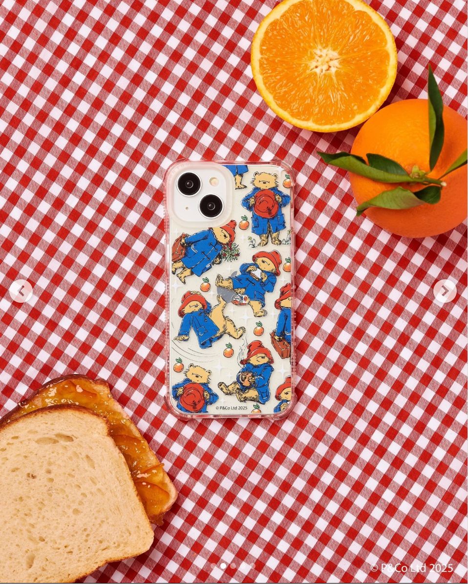 a sandwich and oranges on a red and white checkered table cloth