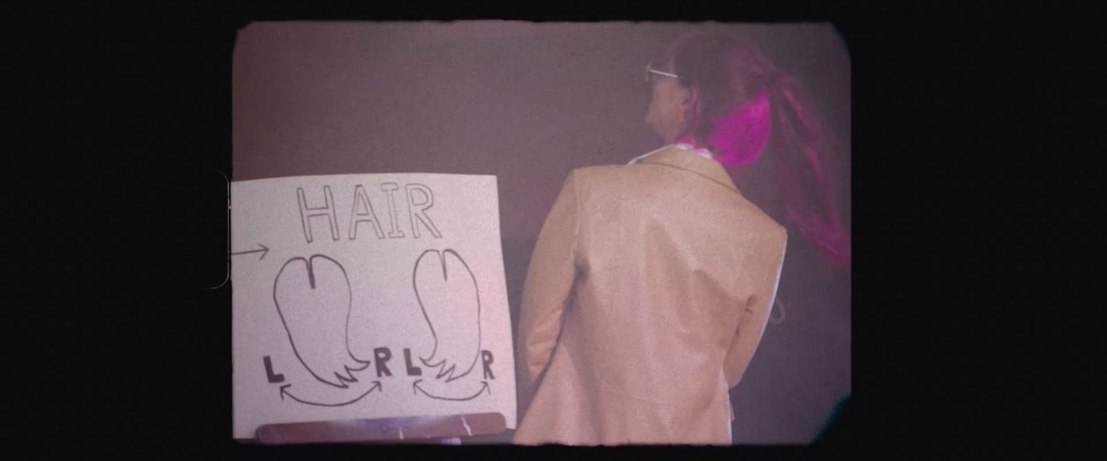 a man holding a sign that says hair loss