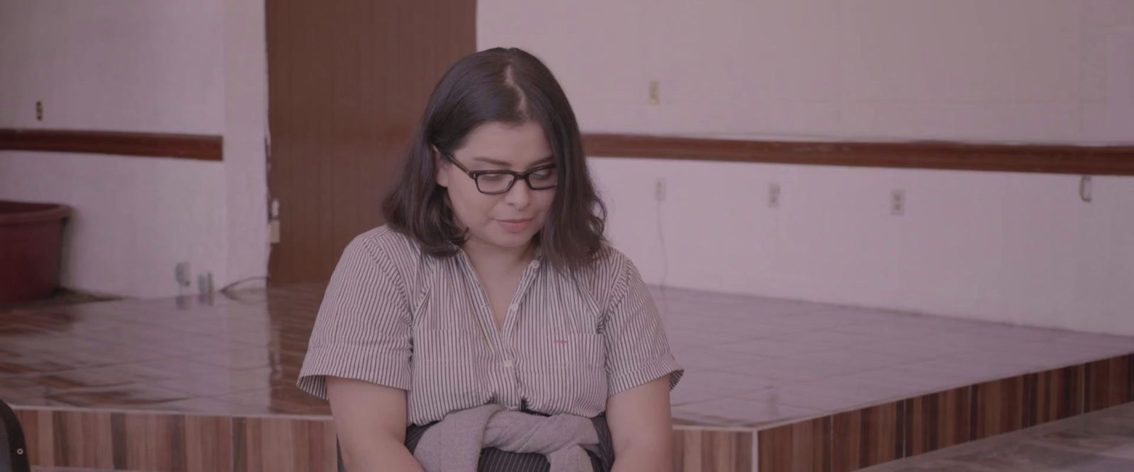 a woman sitting on a chair in a room